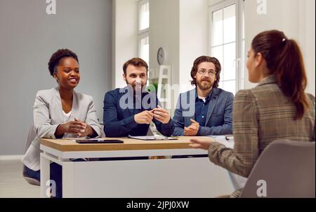 Friendly human resources commission interviewing woman during meeting in office. Stock Photo