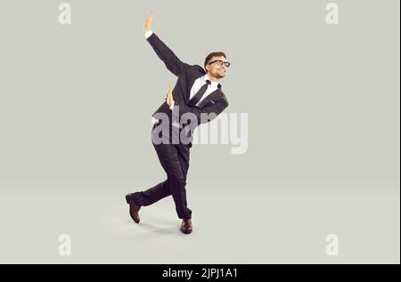 Full length studio shot of happy businessman or office worker dancing and having fun Stock Photo