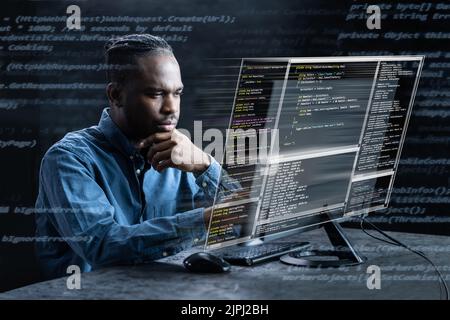 Computer Programmer Writing Program Code On Computer In Office Stock Photo