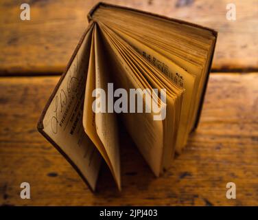A closeup of a vintage book about weights and measures isolated on the oak table Stock Photo