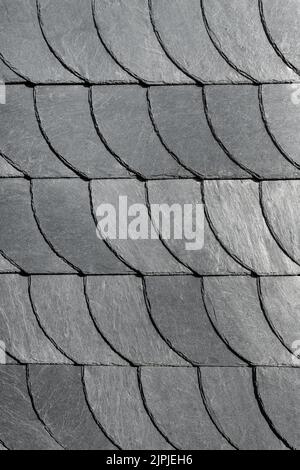Detail close-up of natural grey stone shingle slate tiles texture roof abstract surface background. Natural mineral material dark rock plate building Stock Photo