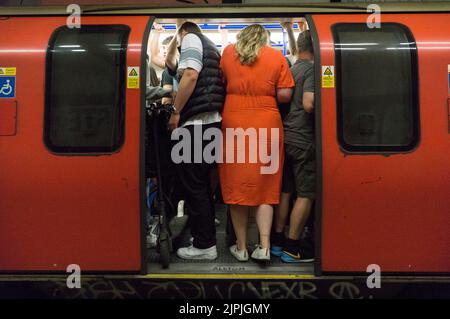 London, UK. 18th Aug, 2022. No overground trains are running in the evening while the RMT union take industrial action in a protest against the pay and pensions conditions offered by rail companies. As a result residents of south London found the late evening tube services much busier than usual as passengers crowded onto the Northern Line instead. Credit: Anna Watson/Alamy Live News Stock Photo