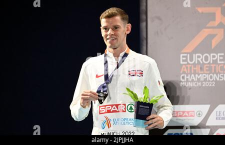 Munich, Germany. 18th Aug, 2022. European Championships, athletics, 1500m, men, final at the Olympic Stadium. Great Britain's Jake Heyward cheers for the silver medal at the award ceremony. Credit: Angelika Warmuth/dpa/Alamy Live News Stock Photo