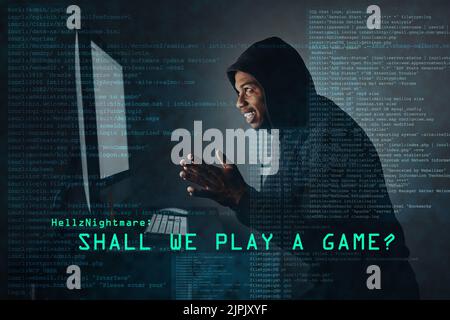 The sinister world of hacking. a hacker cracking a computer code in the dark. Stock Photo