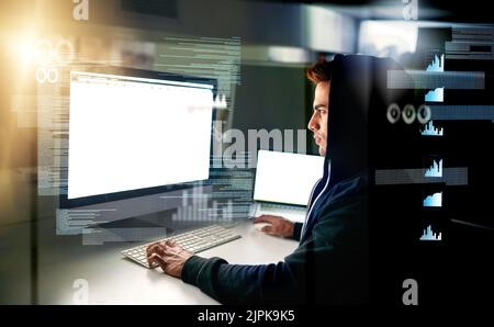 Running diagnostics on his system. a handsome young male computer programmer working on new code. Stock Photo