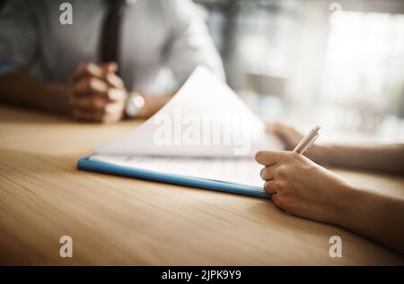 The tests have come through. an unrecognizable businessperson signing papers inside of the office during the day. Stock Photo