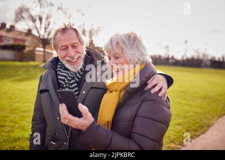 walk, sms, smart phone, older couple, walks, smart phones, smartphone, smartphones, older couples Stock Photo