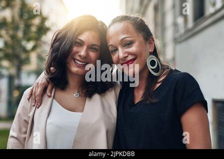 Were the closest friends in this city. two friends posing together while out in the city. Stock Photo