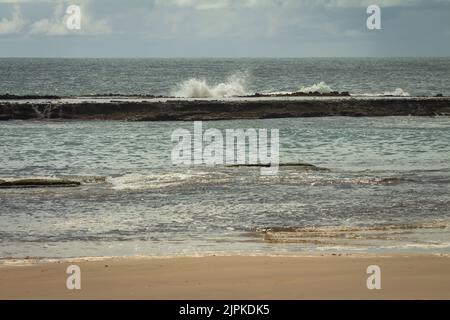 Waves breaking over the barrier reef at Sibauma beach in Rio Grande do Norte. Paradise beach on a stormy day. Stock Photo