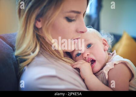 Since day one she snuggled right into moms heart. an adorable baby girl bonding with her mother at home. Stock Photo