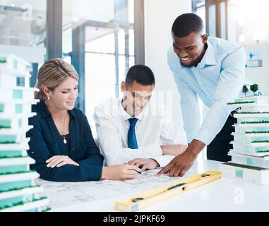 Design, architecture and diversity of a team of architects working on construction blueprint plan. Happy, creative colleagues or engineer planning a Stock Photo