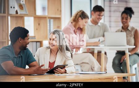 Teamwork, planning and strategy with female leader, senior boss and manager talking to an employee or colleague in the office. Discussing the vision Stock Photo
