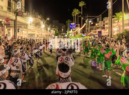 Tokushima, Japan - August 12, 2022: Performers parade down street during crowded Awaodori festival Stock Photo