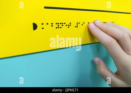 Child's hand is reading braille text Stock Photo