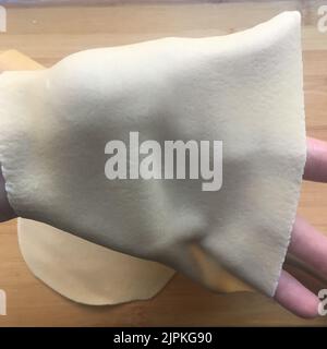 transparent lasagna sheet on a hand Stock Photo