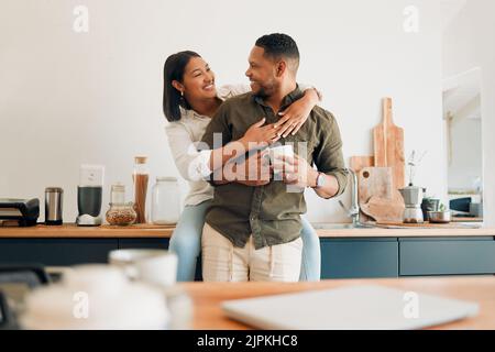 Happy, hugging and romantic couple bonding and feeling united, supported and in love. Cheerful and relaxed married man and woman embracing in home Stock Photo