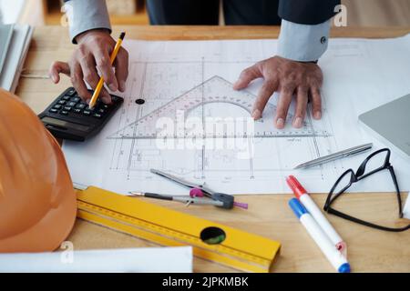 Hands of engineer checking construction plan on his table Stock Photo