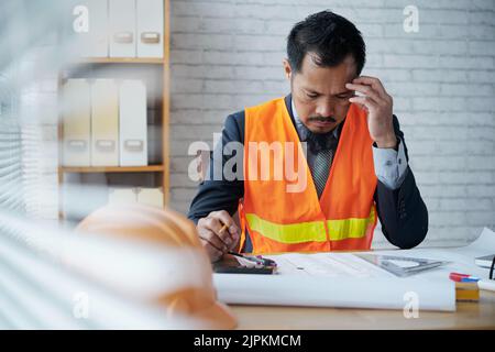 Pensive professional architect working on housing project Stock Photo