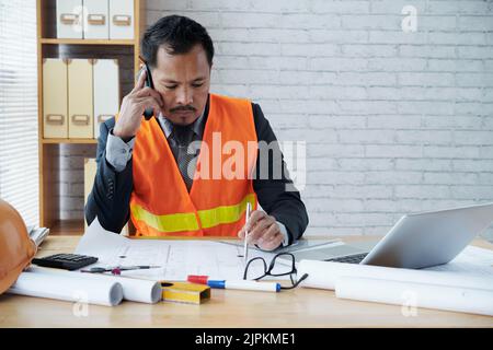 Project manager having phone call and taking notes Stock Photo