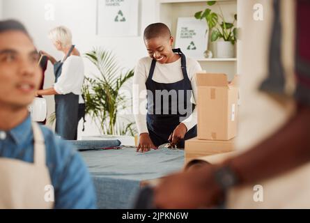 Fashion designer and creative stylist cutting fabric, sewing clothes and planning costume design in workshop. Smiling, happy and young woman in Stock Photo