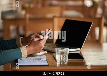 Hands of businessman reading e-mails on his phone Stock Photo