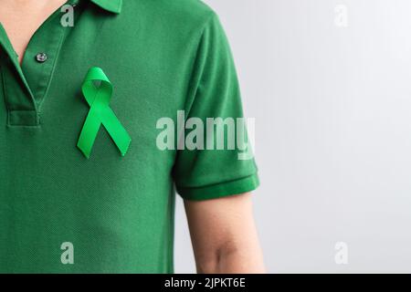 green Ribbon for Liver, Gallbladders, bile duct, cervical, kidney Cancer and Lymphoma Awareness month. Healthcare and world cancer day concept Stock Photo