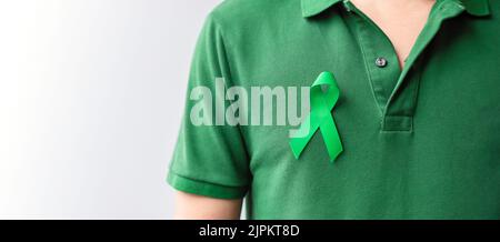 green Ribbon for Liver, Gallbladders, bile duct, cervical, kidney Cancer and Lymphoma Awareness month. Healthcare and world cancer day concept Stock Photo