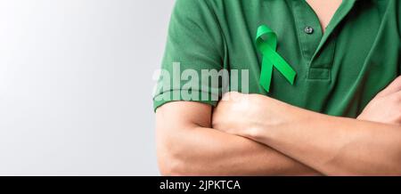 green Ribbon for Liver, Gallbladders, bile duct, cervical, kidney Cancer and Lymphoma Awareness month. Healthcare and world cancer day concept Stock Photo