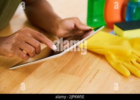 Hands of housewife working on digital tablet Stock Photo