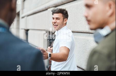 Startup entrepreneur feeling happy and excited while outside with his team looking for opportunity. Motivated and dedicated small business colleagues Stock Photo