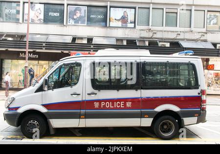 Hong Kong police vehicle on Peking road in Kowloon. the vehicle is Mercedes-Benz van and The windows are protected by bars. Stock Photo