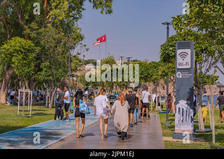 10 July 2022, Antalya, Turkey: Bicycle and a pedestrian path on the Antalya embankment. People are walking and enjoying the weather and the weekend Stock Photo