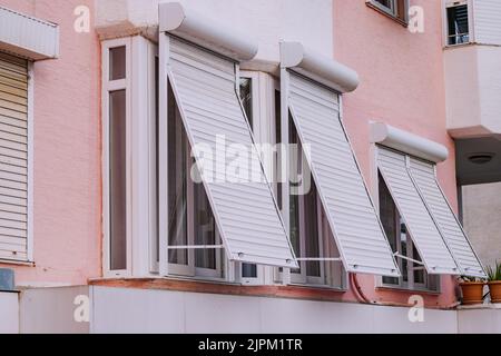 Aluminum folding blinds on the outside of the window. Protection from the sun and from burglary of the apartment Stock Photo