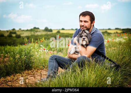 Cheerful Bearded Man Hugging Smiling Woman While Leaning On Cupboard 