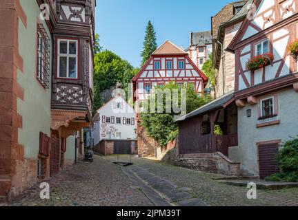 Miltenberg, Germany - July 18, 2021: Traditional houses on the road leading to the castle Stock Photo