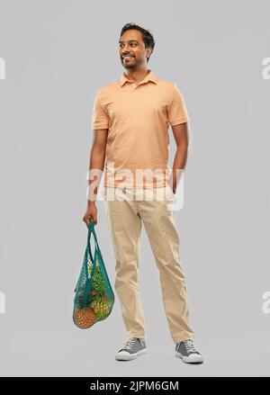 happy indian man with food in reusable net tote Stock Photo