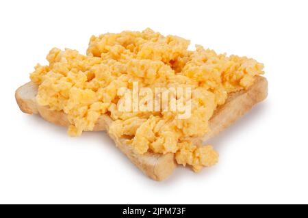 Studio shot of scrambled eggs on toast cut out against a white background - John Gollop Stock Photo