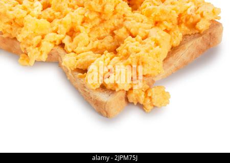 Studio shot of scrambled eggs on toast cut out against a white background - John Gollop Stock Photo