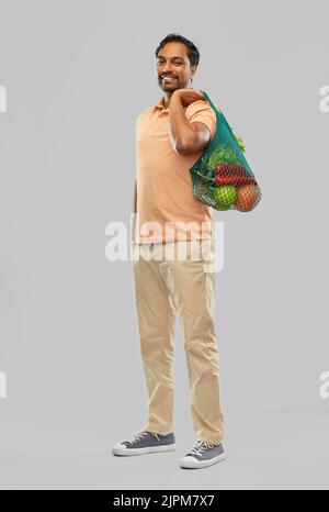 happy indian man with food in reusable net tote Stock Photo
