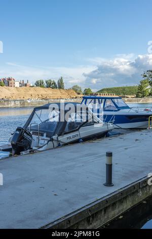 A vertical shot of boats parked in a pier in the sunset Stock Photo - Alamy