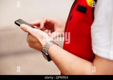 Delivery man looked at the phone for the future route Stock Photo