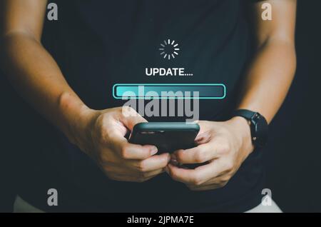 Hand holding mobile smartphone digital technology communication online update software system application virtual screen concept. Stock Photo