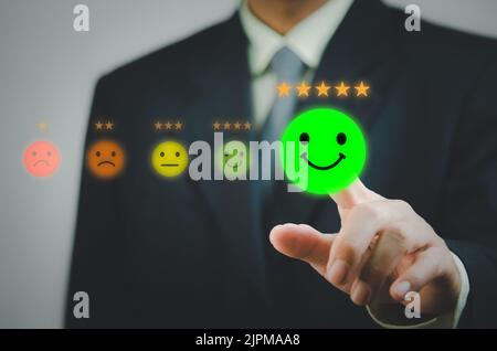 Man hand touch virtual screen emotion service and customer review feedback rating good and best five stars. Stock Photo