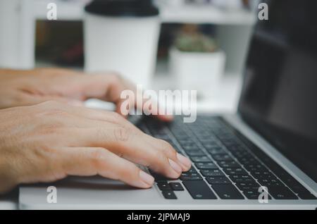 Person man hand typing keyboard computer communication internet online information and searching social digital marketing concept. Stock Photo