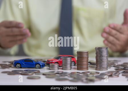 Coin money stack and car toy business investment accounting finance inflation growth.Saving money economics plan insurance concept. Stock Photo