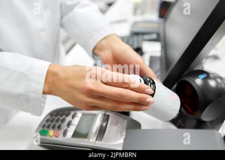 close up of pharmacist with medicine at pharmacy Stock Photo
