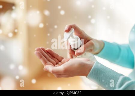 close up of woman applying hand sanitizer Stock Photo