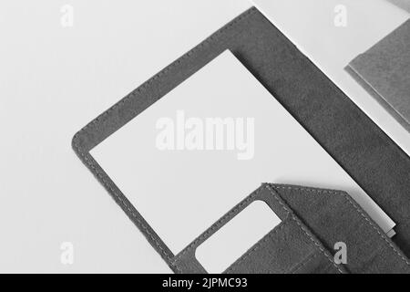 Minimal Desk Flatlay. Office Folder with Blank White Paper Sheets and Cards on White Background. Stock Photo