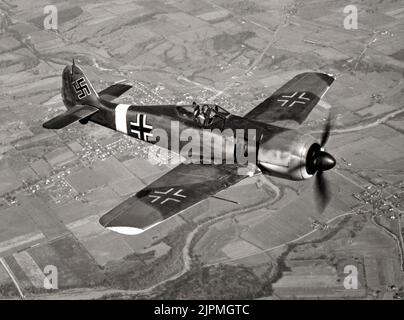 A German Focke-Wulf FW 190 fighter in flight. The aircraft was a German single-seat, single-engine fighter  designed in the late 1930s and started flying operationally over France in August 1941 and quickly proved superior in all but turn radius to the Spitfire Mk. V, the main front-line fighter of the Royal Air Force (RAF), particularly at low and medium altitudes.The 190 maintained superiority over Allied fighters until the introduction of the improved Spitfire Mk. IX. Stock Photo