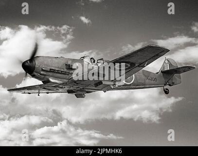 A captured Messerschmitt Bf 109E-3, DG200, in flight while serving with No. 1426 (Enemy Aircraft) Flight. The aircraft was force-landed at Manston, Kent, on 27 November 1940, after being attacked by Supermarine Spitfires of No. 66 Squadron RAF over the Thames estuary. After repair at the Royal Aircraft Establishment it was delivered to Rolls-Royce Ltd in 1941 for engine performance tests. It was later passed to the Aircraft and Armament Experimental Establishment at Boscombe Down, and put into storage. Stock Photo